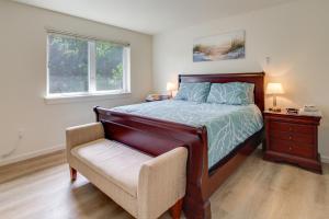 a bedroom with a bed and a chair and a window at Spacious Bandon Getaway - 2 Blocks to Ocean! in Bandon