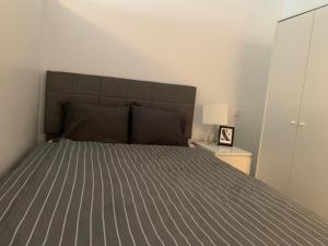 a bedroom with a bed with a gray comforter at Chambre Lux in Luxembourg