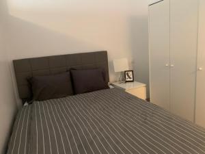 a bedroom with a bed with a gray comforter at Chambre Lux in Luxembourg