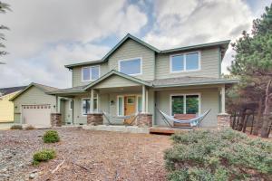 a house with two hammocks on the front porch at Spacious Bandon Getaway - 2 Blocks to Ocean! in Bandon