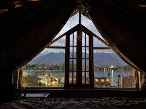 a window in a room with a view of a lake at Weather cottage in Srinagar