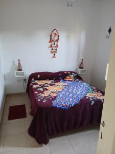 a bedroom with a bed with a blanket on it at Casa Chardonnay in Luzuriaga