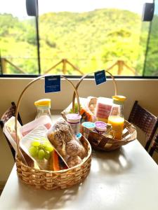 two baskets of bread and juice on a table at Casa Araucária in Cunha +19 photos