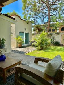 a patio with a couch and a table in a yard at Quinta Los Caballos in Ajijic