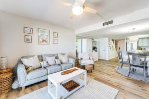 a living room with a couch and a table at Beachfront! Indian Rocks Beach Condo w/ Balcony in Clearwater Beach