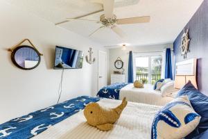 a bedroom with two beds and a teddy bear on the bed at Beachfront! Indian Rocks Beach Condo w/ Balcony in Clearwater Beach