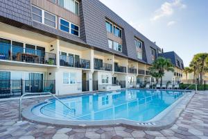 a swimming pool in front of a building at Beachfront! Indian Rocks Beach Condo w/ Balcony in Clearwater Beach