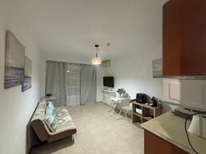 a living room with a couch and a table at Apartamentos Amy 5 in Huelva