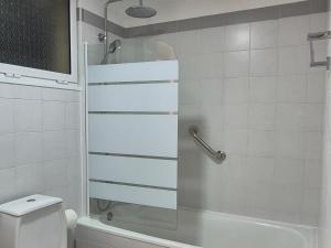 a bathroom with a shower and a toilet at Spacious Bright Apartament with Ocean Views in Caniço +11 photos