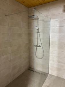 a shower with a glass door in a bathroom at NEW - Mullerthal Basecamp - Sleeps 6 in Beaufort +12 photos