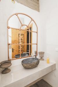 a bathroom with a large stone sink and a mirror at GAIA - Boutique Retreat in Marathopoli +150 photos