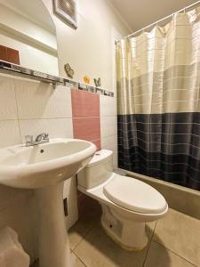 a bathroom with a toilet and a sink at Hotel Virgen del Carmen - Huaraz in Huaraz +23 photos