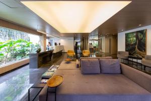 a living room with a couch and a table at Victoria Place By HX in São Paulo