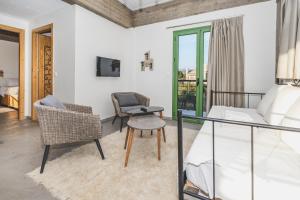 a bedroom with a bed and a chair at GAIA - Boutique Retreat in Marathopoli