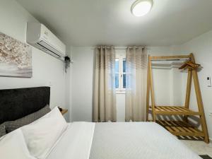 a bedroom with a bed and a window at The Central Retreat 1 in Mytilene +11 photos