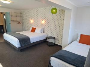 a hotel room with two beds at RotoVegas Motel of Rotorua in Rotorua
