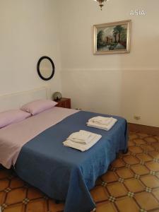 a bedroom with a bed with two towels on it at Dimora Benedetta 2 0 in Bari