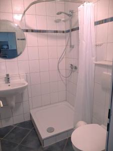 a bathroom with a shower and a toilet and a sink at FW Knütel Nr 57 in Burgtiefe auf Fehmarn 