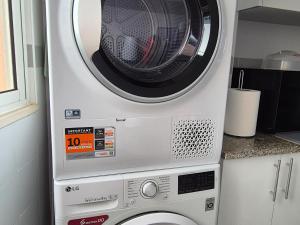 a washer and dryer in a kitchen at Spacious Bright Apartament with Ocean Views in Caniço
