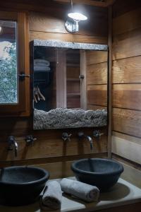 a bathroom with two sinks and a mirror at Orion Treehouses in Saint Paul de Vence +64 photos