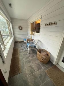 a porch with two chairs and a table and a window at Effortless access to ski slopes•Endless relaxation in Beech Mountain