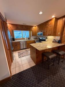 a kitchen with wooden cabinets and a counter top at Effortless access to ski slopes•Endless relaxation in Beech Mountain