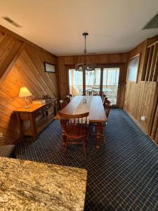 a dining room with a wooden table and chairs at Effortless access to ski slopes•Endless relaxation in Beech Mountain