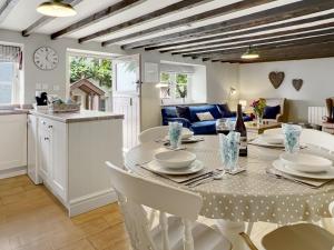 a kitchen and living room with a table and chairs at The Old Malt House Exton in Exton +9 photos