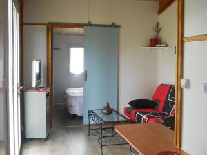 a living room with a couch and a television at chalet nature 2 in Aspiran