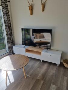 a living room with a white cabinet and a table at La Maison des Muses in Arles