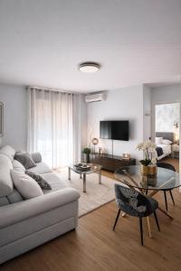 a living room with a couch and a table at Apartamentos Abril in Nerja