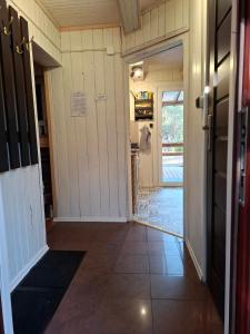 an open hallway with a door leading to a kitchen at Leśna chatka in Wilga +24 photos