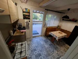 an aerial view of a kitchen with a table and a window at Leśna chatka in Wilga