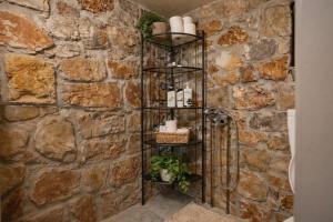 a bathroom with a stone wall at Estate Tsiati in Piryiótika