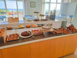a buffet line with many different types of food at Hotel Iones in Rimini