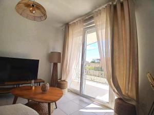 a living room with a table and a large window at Cozy Home in Roussillon en Isere