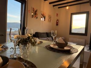 a dining table with glasses and a bowl on it at Casa Cuartel in Redondela