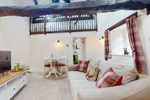 a living room with a couch and a table at The Barn Timberscombe in Timberscombe