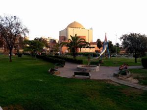 a park with benches and a building in the background at Flat via Irlanda 26 in Quartu Sant'Elena