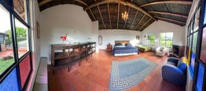 a large living room with a bed and a couch at Antara House in Guasca