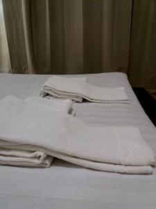 two white blankets sitting on top of a bed at Flat via Irlanda 26 in Quartu Sant'Elena +55 photos