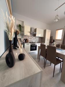 a kitchen with a table with two vases on it at La Mya Aurora in Finale