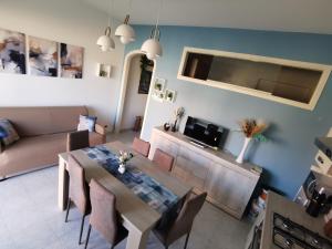 a living room with a table and a couch at La Mya Aurora in Finale