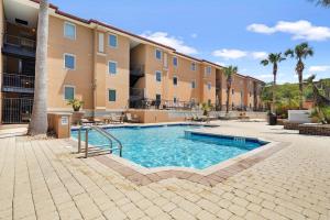 a swimming pool in front of a building at Brass Rail 310 in Tybee Island