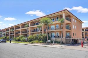 an apartment building with palm trees in front of it at Brass Rail 310 in Tybee Island
