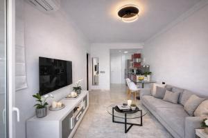 a living room with a couch and a tv at Abril Nerja in Nerja