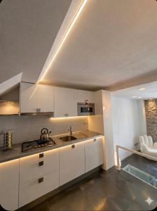 a kitchen with white cabinets and a sink at Silver Flat in Vernazza +21 photos