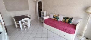 a bedroom with a bed and a table and chairs at La Casetta di Mari in Legnano