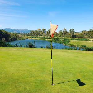 a flag in the middle of a golf course at Flat via Irlanda 26 in Quartu Sant'Elena