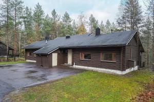 a log cabin with a parking lot in front of it at Mökki Vierumäki in Myllykylä